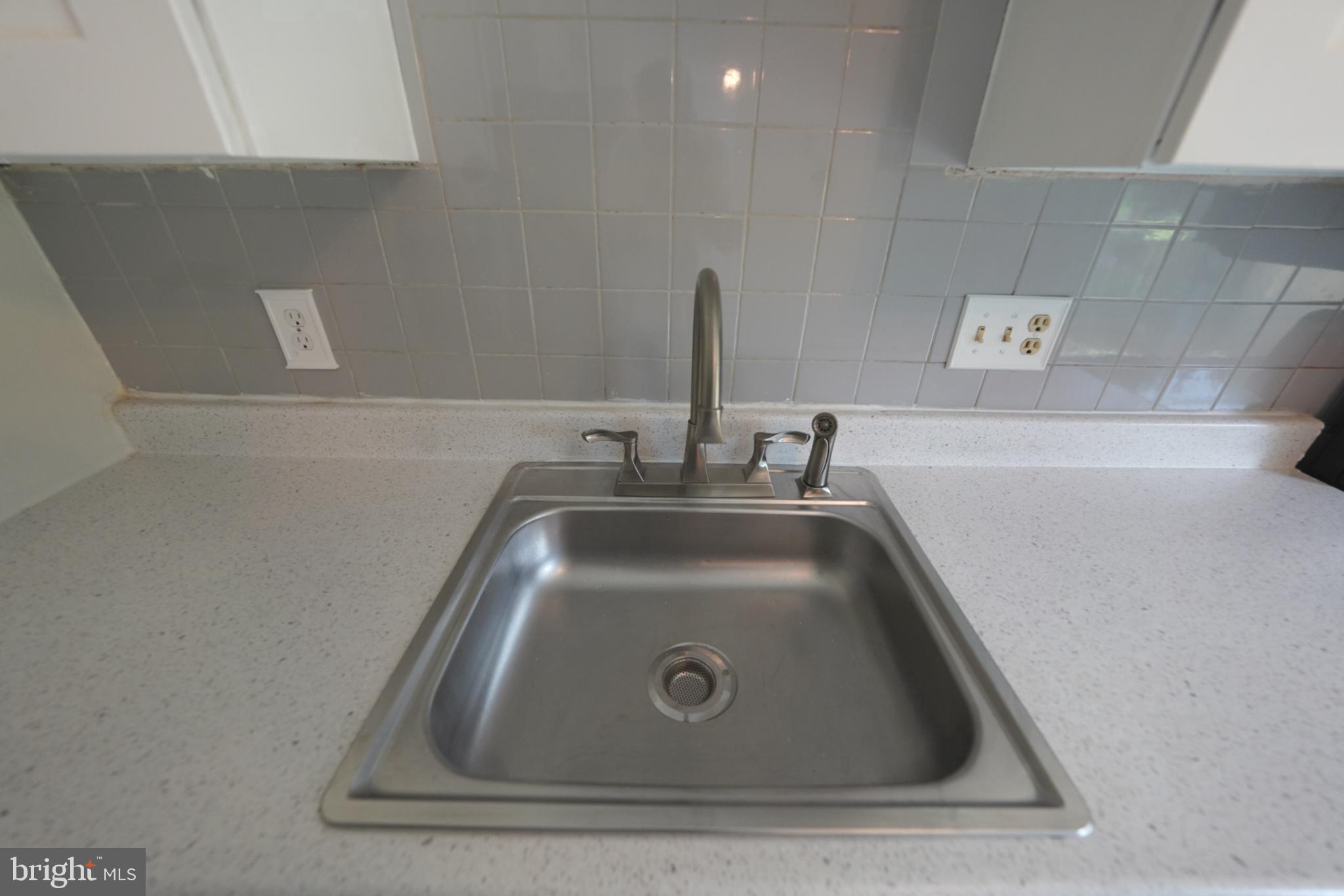 8997 Centerway Road Gaithersburg, MD 20879 - Photo 22 of 71 a close view of sink and tap