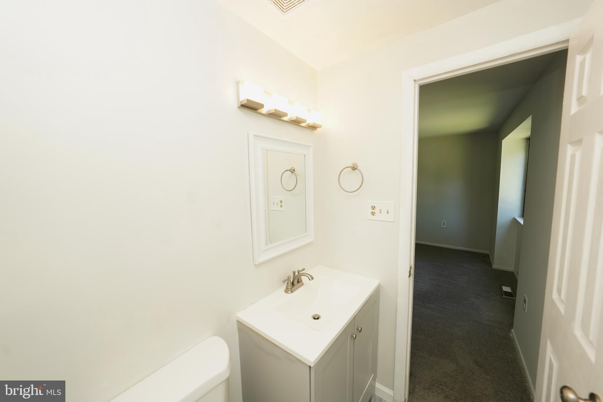 8997 Centerway Road Gaithersburg, MD 20879 - Photo 49 of 71 a bathroom with a bathtub sink and mirror