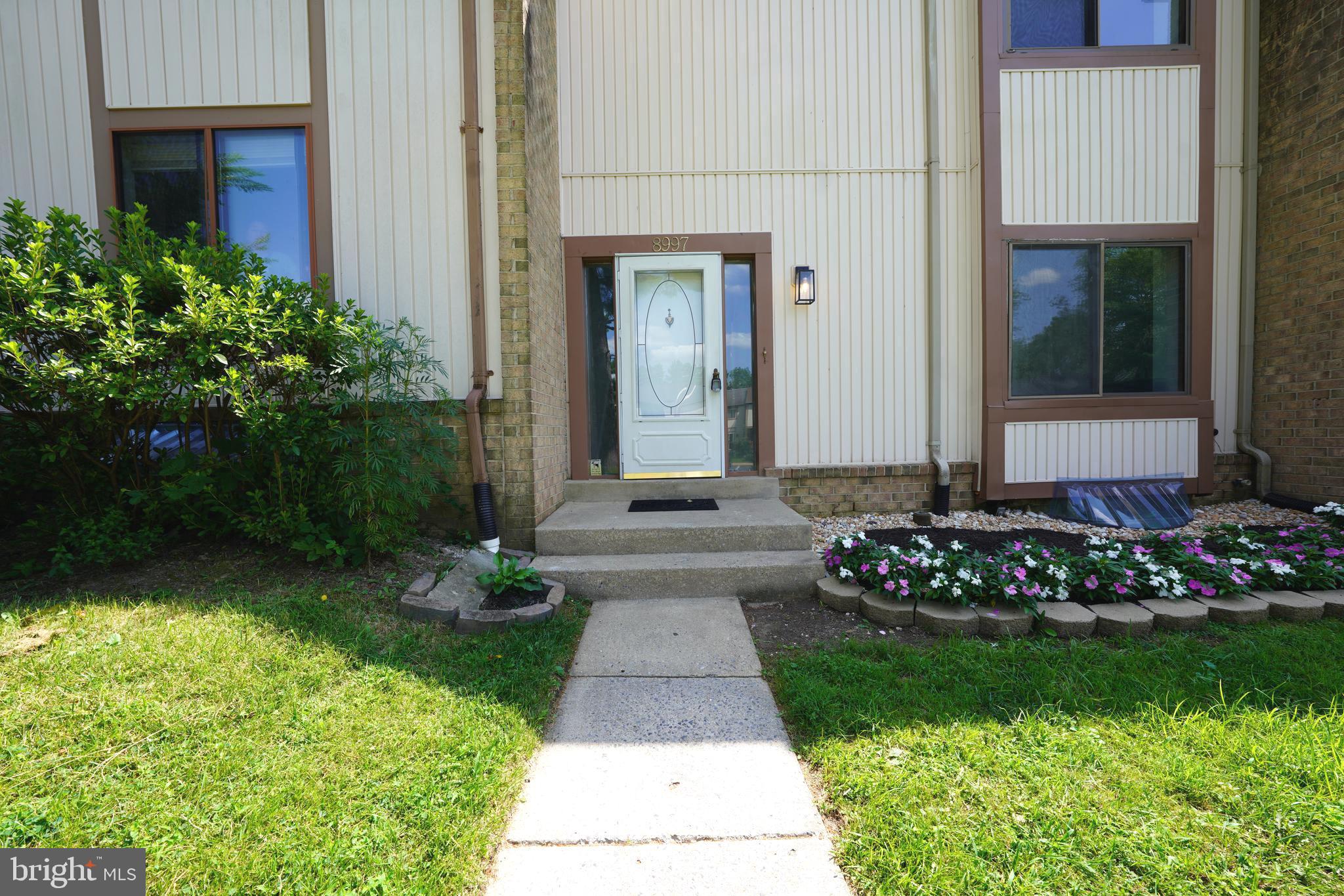 8997 Centerway Road Gaithersburg, MD 20879 - Photo 5 of 71 a front view of a house with a yard