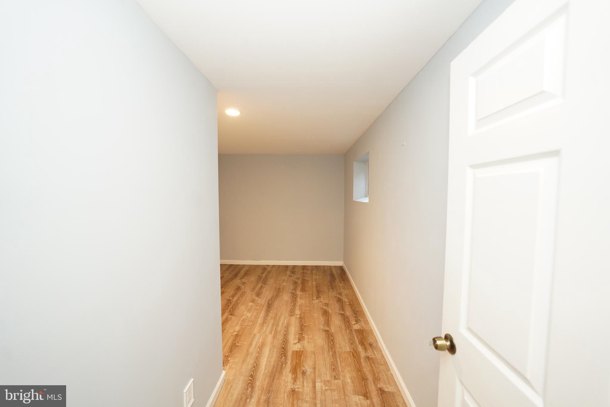 8997 Centerway Road Gaithersburg, MD 20879 - Photo 52 of 71 a view of a hallway with wooden floor
