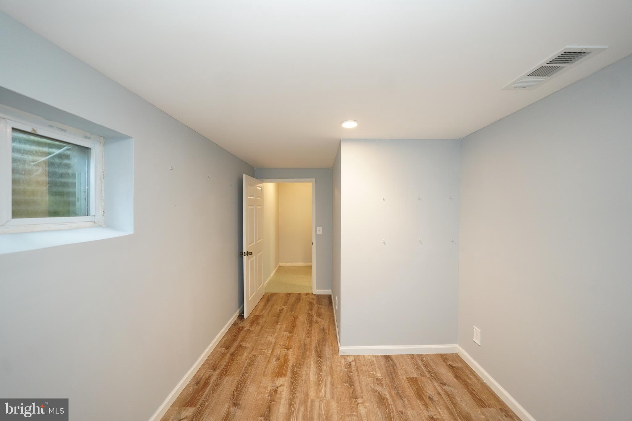 8997 Centerway Road Gaithersburg, MD 20879 - Photo 54 of 71 a view of a room with wooden floor and staircase
