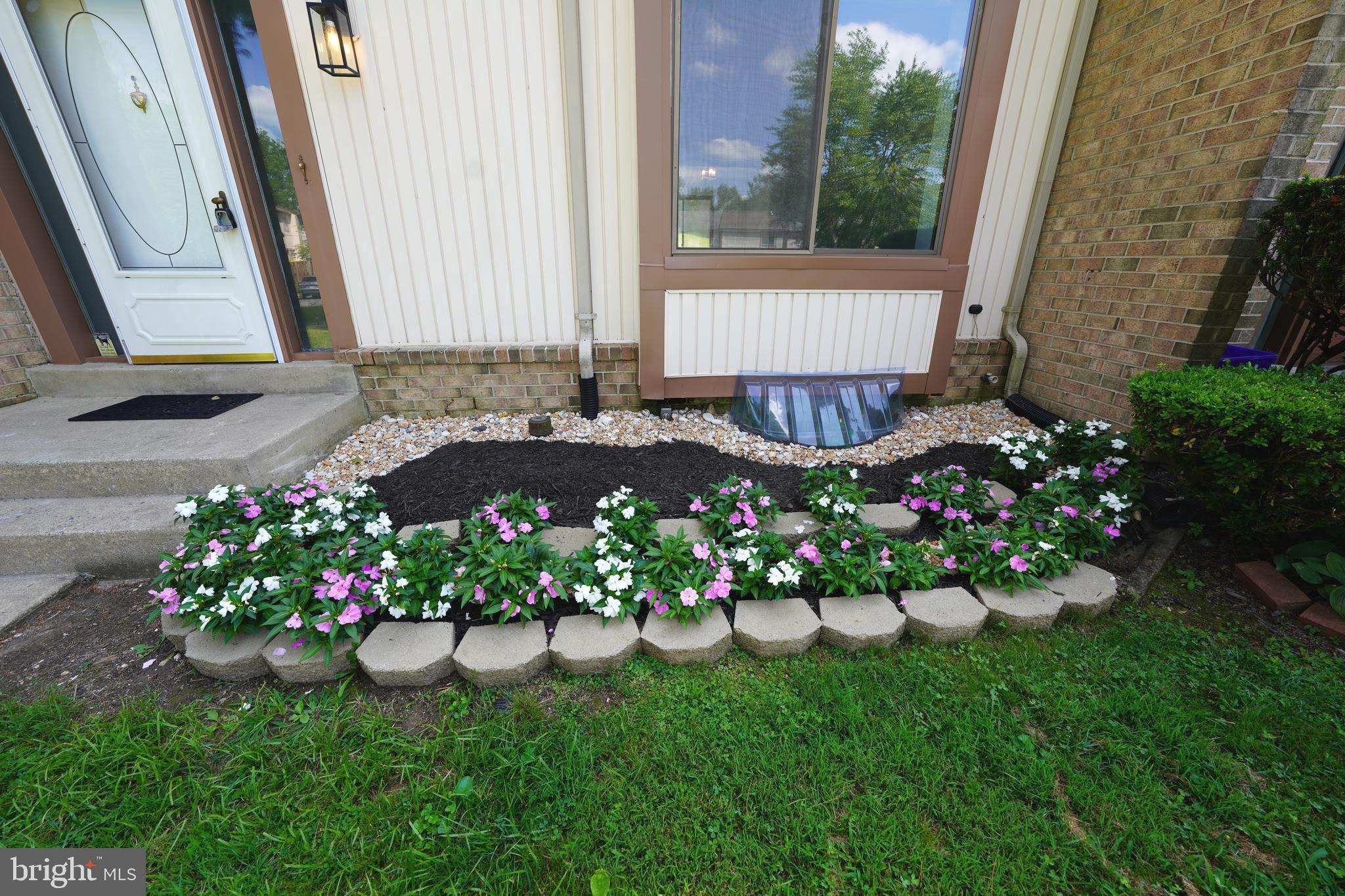 8997 Centerway Road Gaithersburg, MD 20879 - Photo 6 of 71 a view of a flowers in front of a house