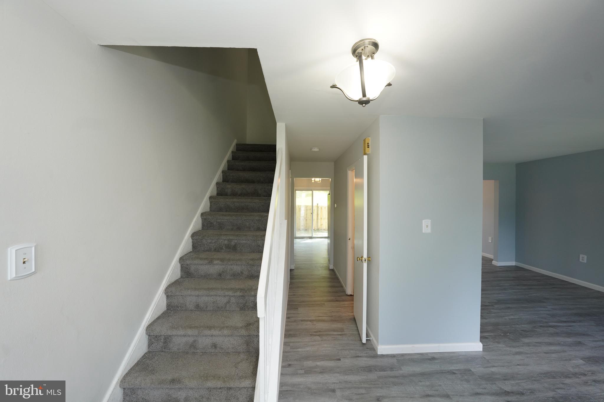 8997 Centerway Road Gaithersburg, MD 20879 - Photo 8 of 71 a view of entryway and hall with wooden floor