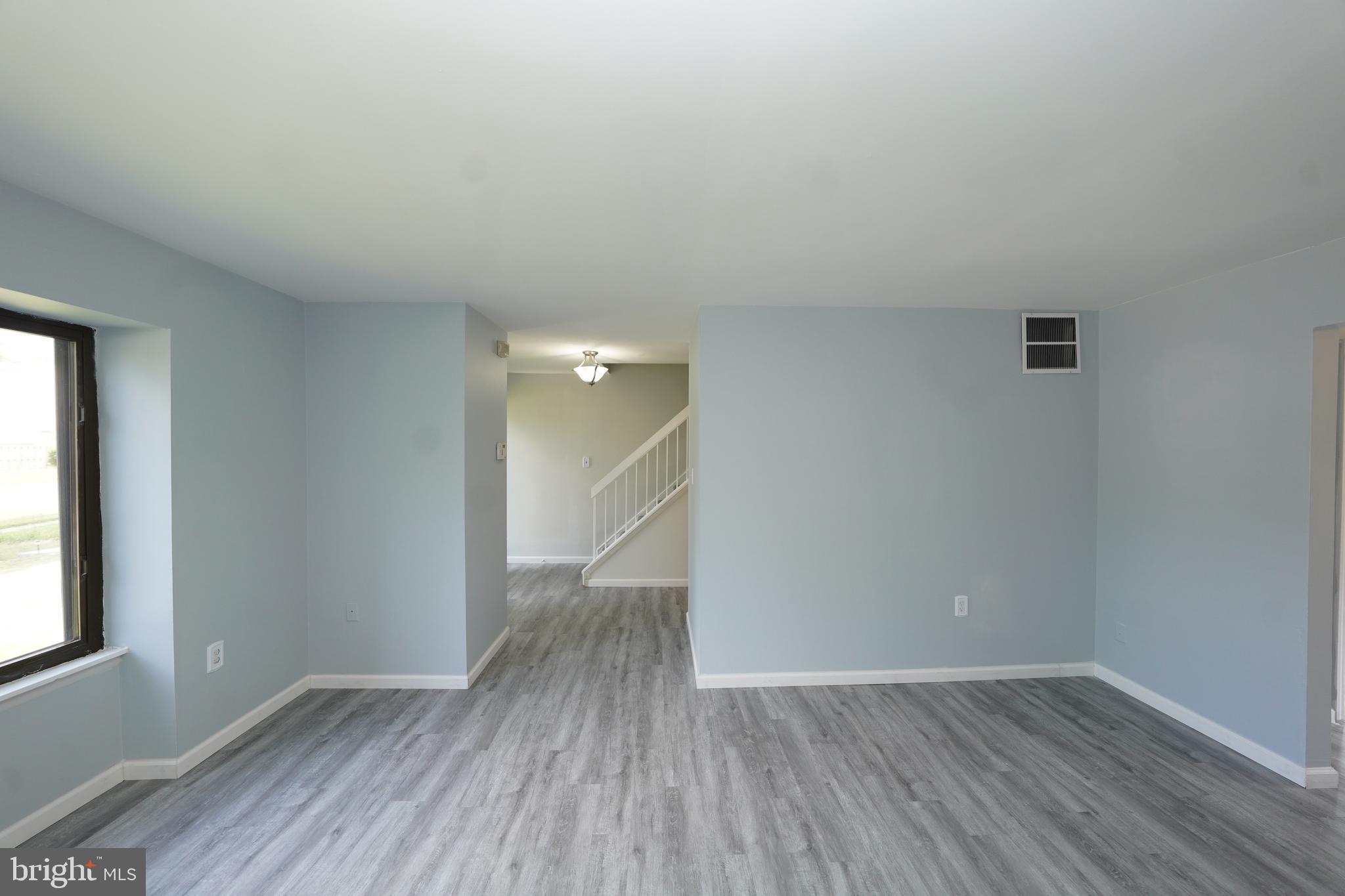 8997 Centerway Road Gaithersburg, MD 20879 - Photo 10 of 71 wooden floor in an empty room with a window