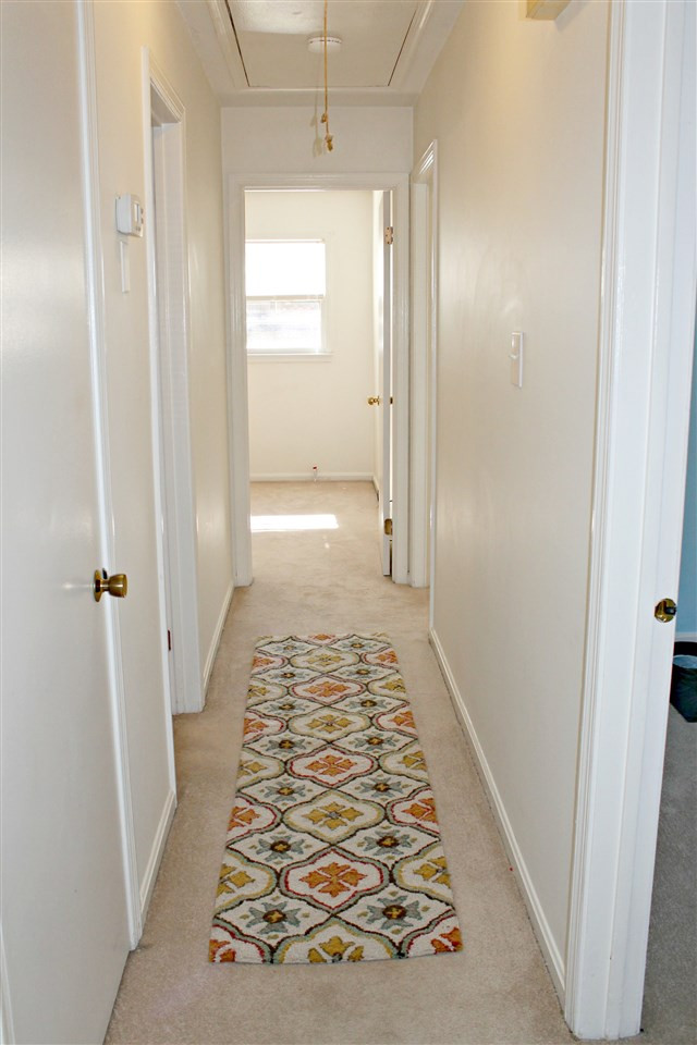 6922 Innesbrook Way Bahama, NC 27503 - Photo 4 of 11 Hallway with pull down floored attic space for extra storage Hallway