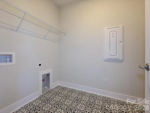 a view of a small space with wooden floor and a window