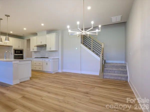 a view of kitchen with cabinets and wooden floor