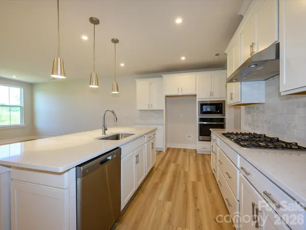 a kitchen with sink a stove and refrigerator