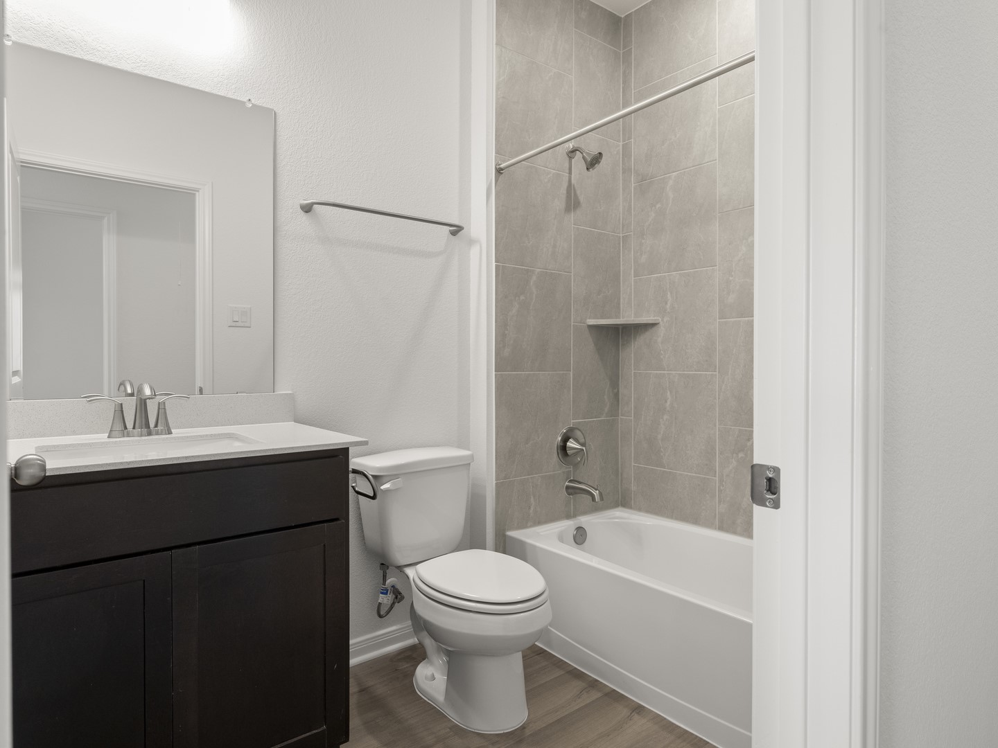 513 Yellow Ribbon Trail Jarrell, TX 76537 - Photo 14 of 23 A well-appointed bath features a tiled shower surround and a practical vanity.