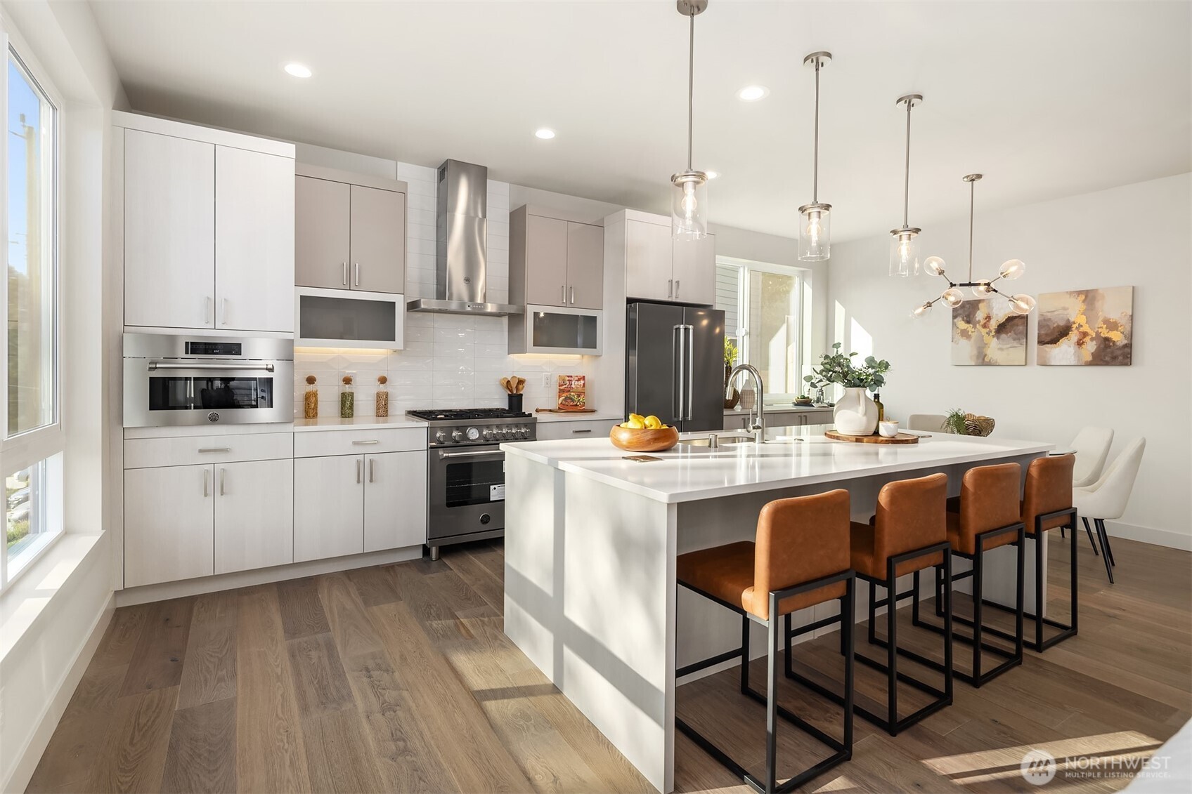 4572 22nd Avenue Southwest Seattle, WA 98106 - Photo 11 of 40 a kitchen with stainless steel appliances kitchen island granite countertop a table chairs sink and cabinets