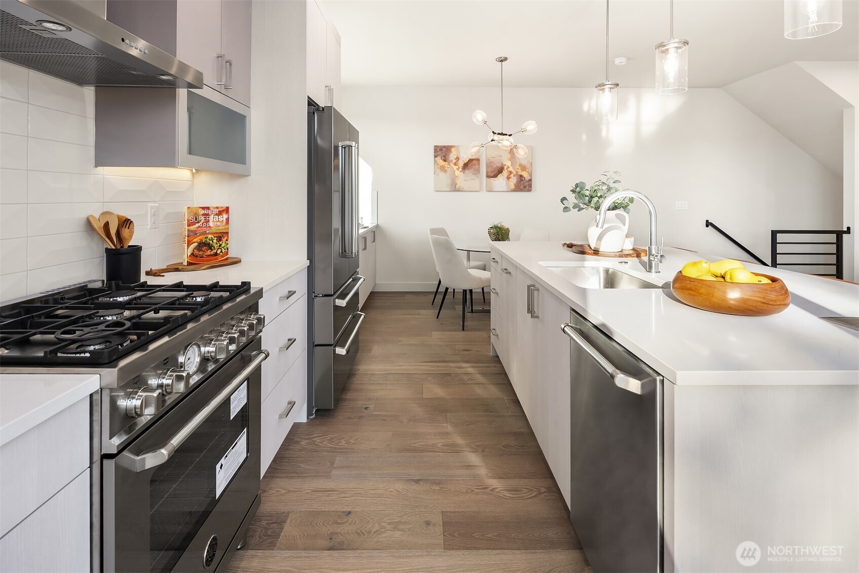 4572 22nd Avenue Southwest Seattle, WA 98106 - Photo 12 of 40 a kitchen with stainless steel appliances a stove a sink and a refrigerator