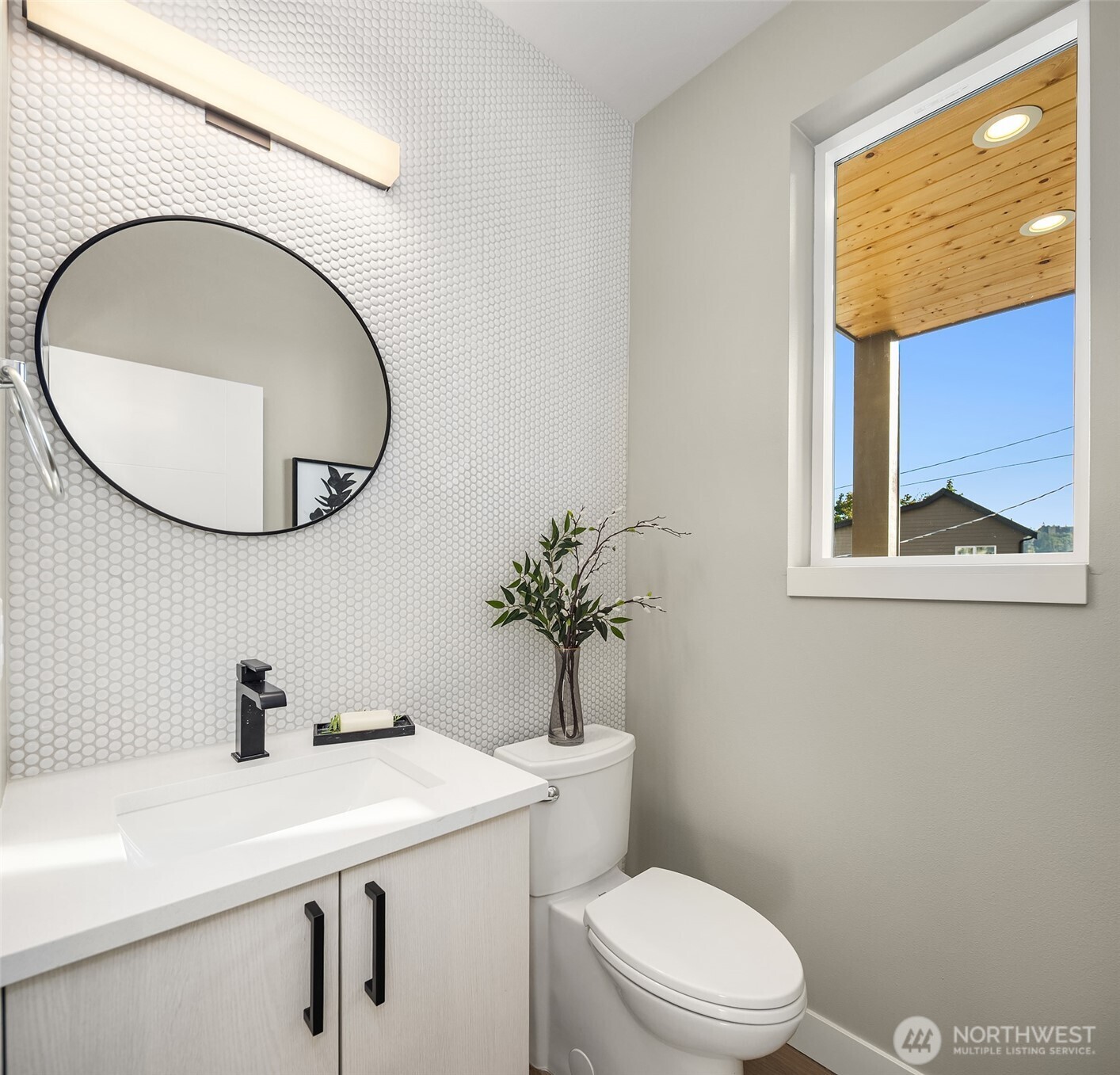 4572 22nd Avenue Southwest Seattle, WA 98106 - Photo 24 of 40 a bathroom with a sink a mirror and a toilet