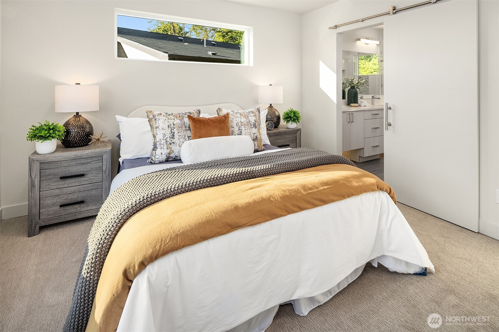 4572 22nd Avenue Southwest Seattle, WA 98106 - Photo 27 of 40 a bed sitting in a bedroom next to a window with potted plants