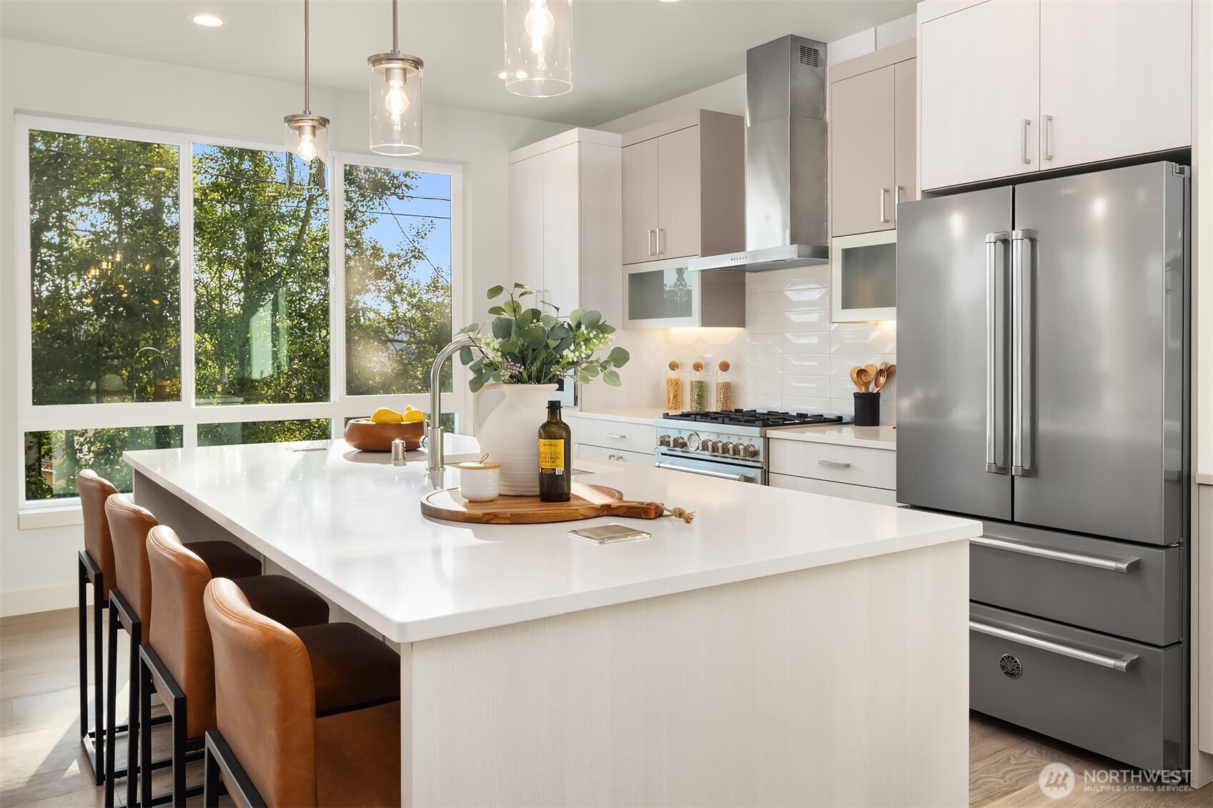 4572 22nd Avenue Southwest Seattle, WA 98106 - Photo 9 of 40 a kitchen with kitchen island a counter and a refrigerator