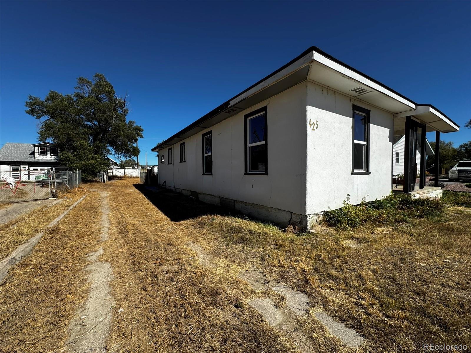425 5th Street Hugo, CO 80821 - Photo 4 of 13 a front view of a house with a yard