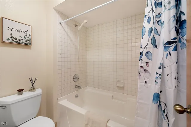 a bathroom with a toilet and a tub