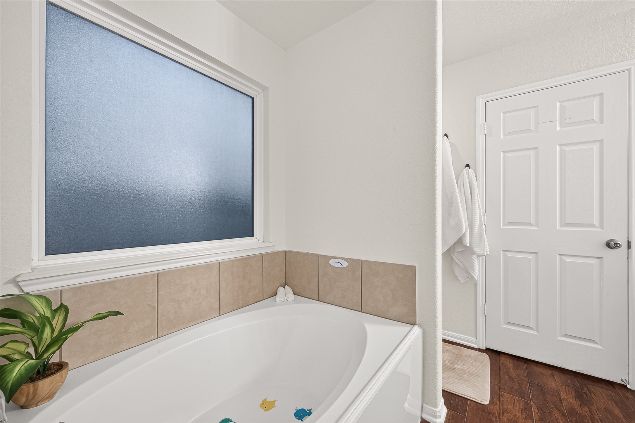 3155 View Valley Trail Katy, TX 77493 - Photo 36 of 50 Deep soaking tub surrounded by elegant tile work and a large window for peaceful natural light
