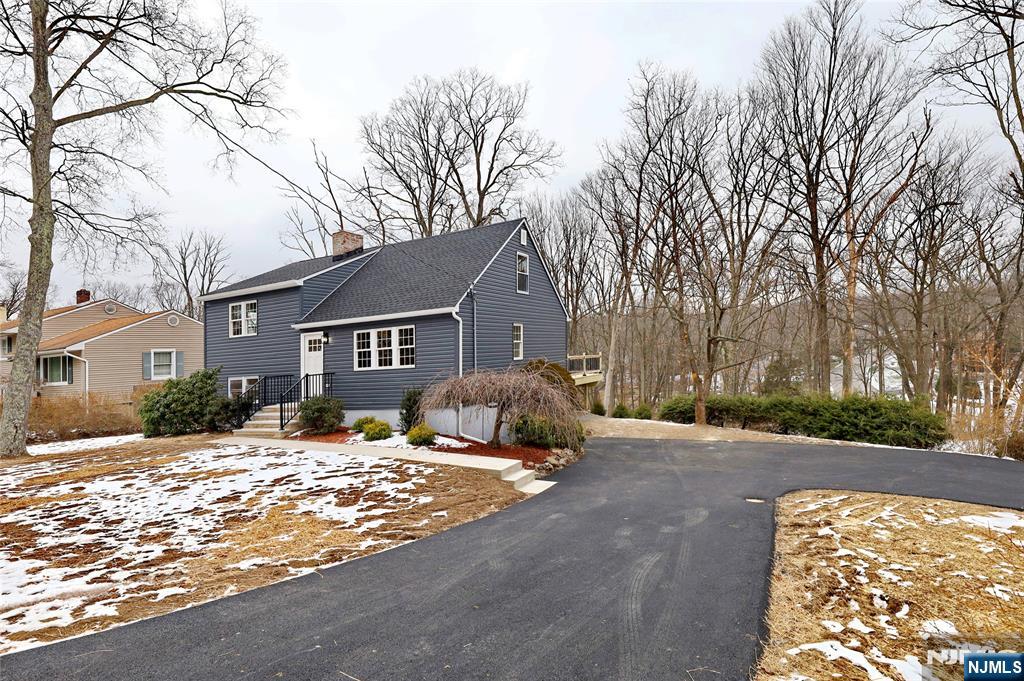 448 Morsetown Road West Milford, NJ 07480 - Photo 1 of 27 a front view of a house with a yard covered in snow