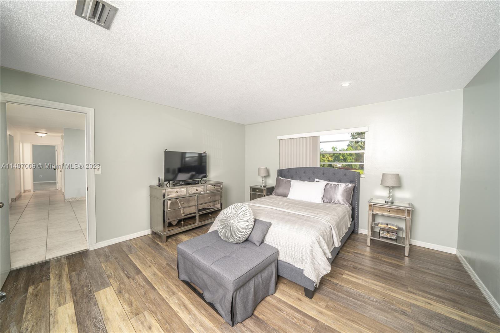 2403 Pasco Drive Sebring, FL 33870 - Photo 16 of 36 a bedroom with a bed and a flat screen tv