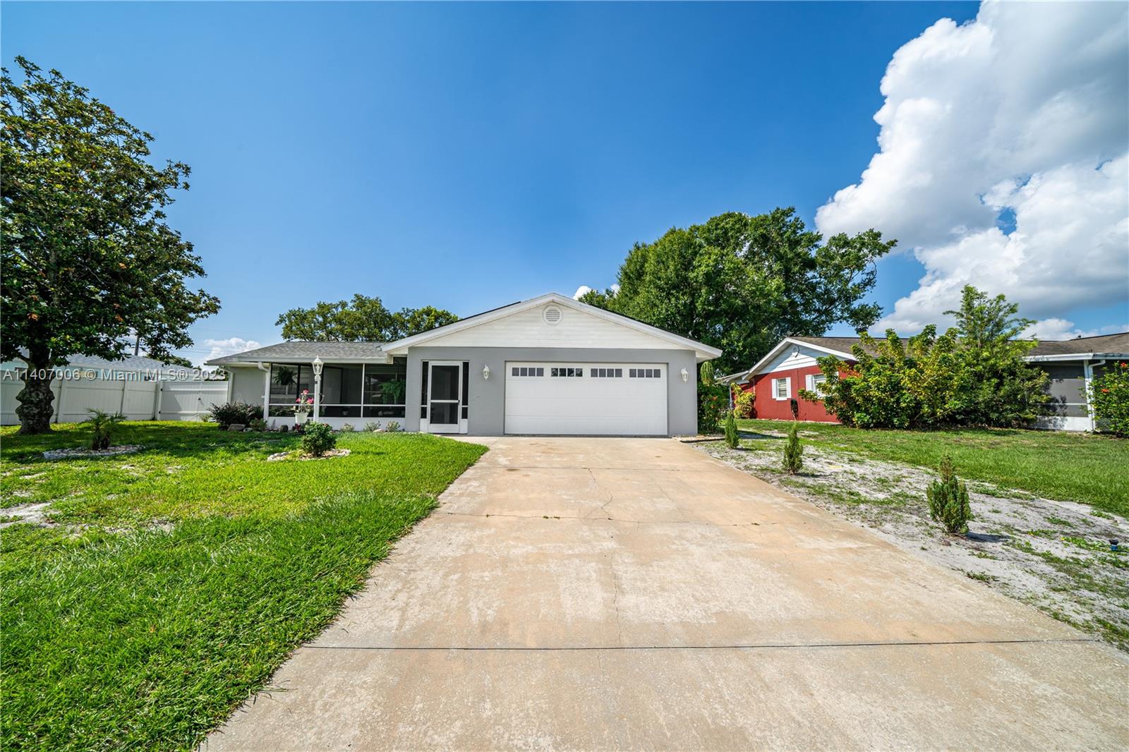 2403 Pasco Drive Sebring, FL 33870 - Photo 2 of 36 a front view of a house with a yard and garage