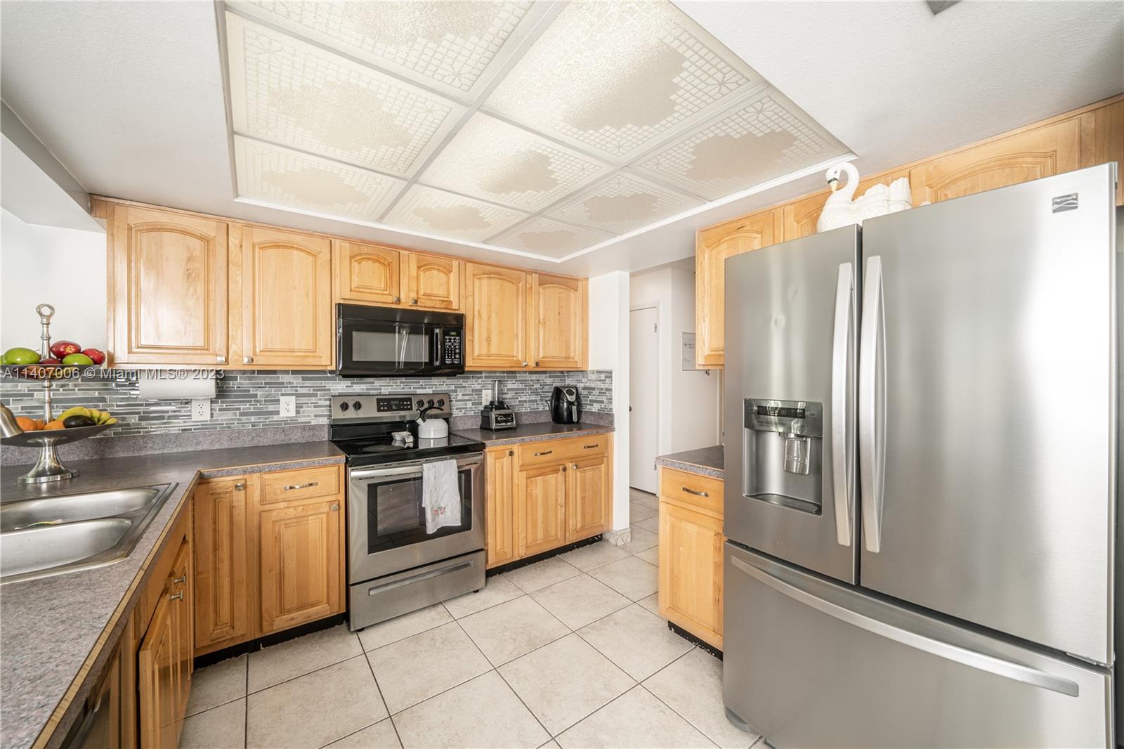 2403 Pasco Drive Sebring, FL 33870 - Photo 27 of 36 a kitchen with stainless steel appliances granite countertop a refrigerator a stove top oven a sink and dishwasher