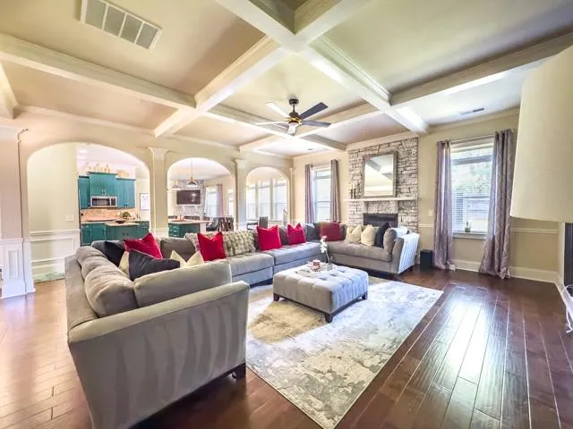 a living room with furniture and wooden floor