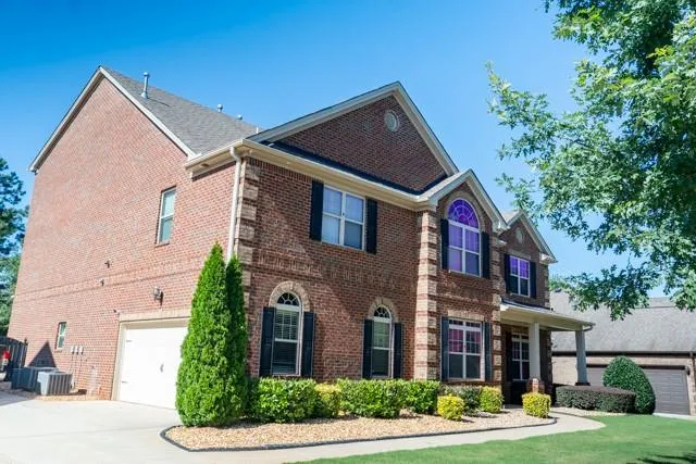 a front view of a house with garden
