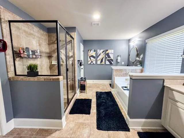 a kitchen with granite countertop a refrigerator a sink and wooden floor