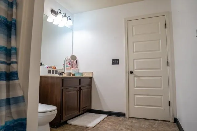 a bathroom with a sink a toilet and a mirror