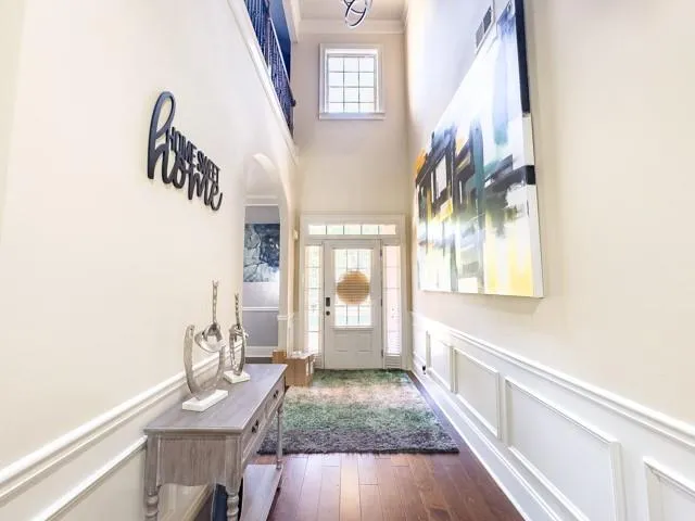a hallway with a large window and a rug