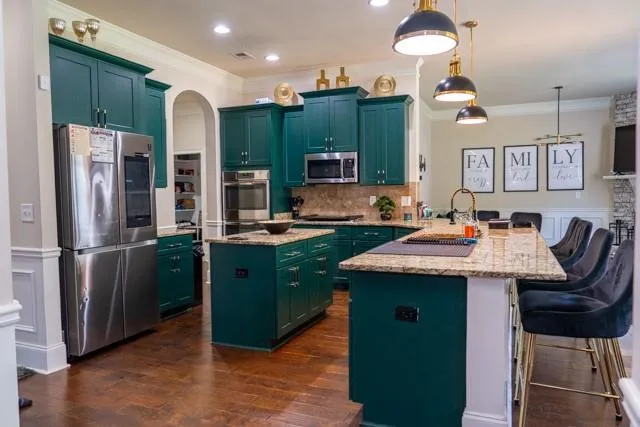 a kitchen with cabinets and stainless steel appliances