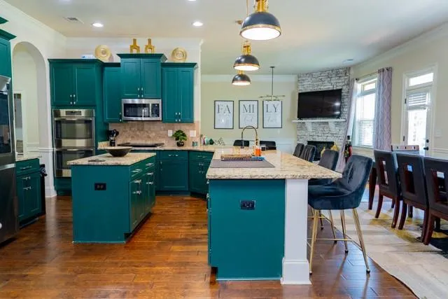 a kitchen with cabinets a sink and appliances