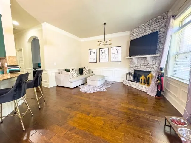 a living room with fireplace furniture and a flat screen tv