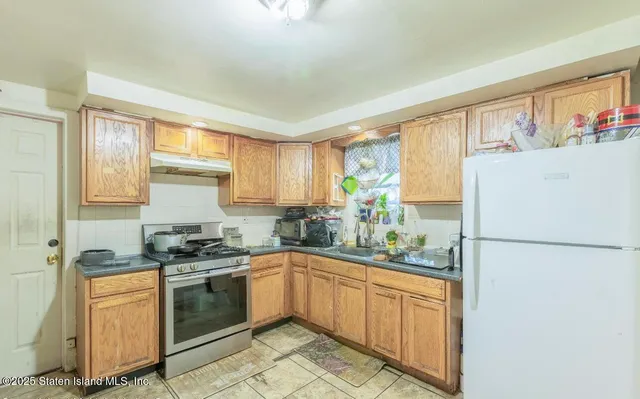 a kitchen with a sink stove and refrigerator