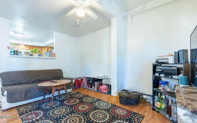 a living room with furniture a rug and a bookshelf