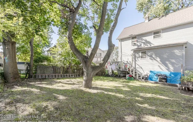 a view of a yard with a tree