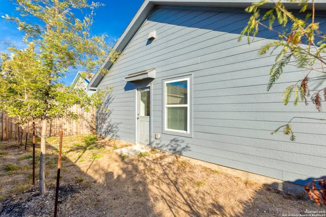 a view of a house with a backyard