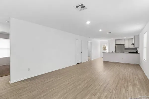 a view of a kitchen with a sink and a stove top oven
