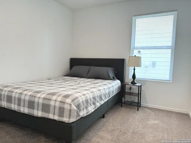 a bedroom with a bed and window