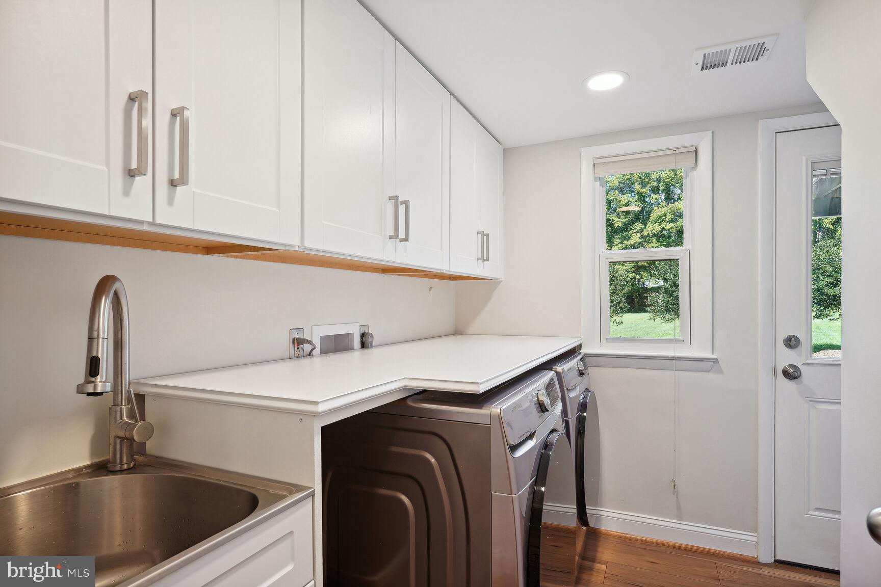 10511 South Glen Road Potomac, MD 20854 - Photo 30 of 44 Laundry Room with Cabinetry/ Sink & Outside Door