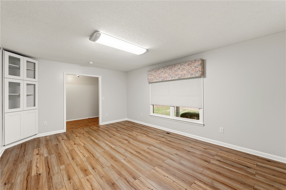 A well-lit area features built-in storage and durable wood flooring.