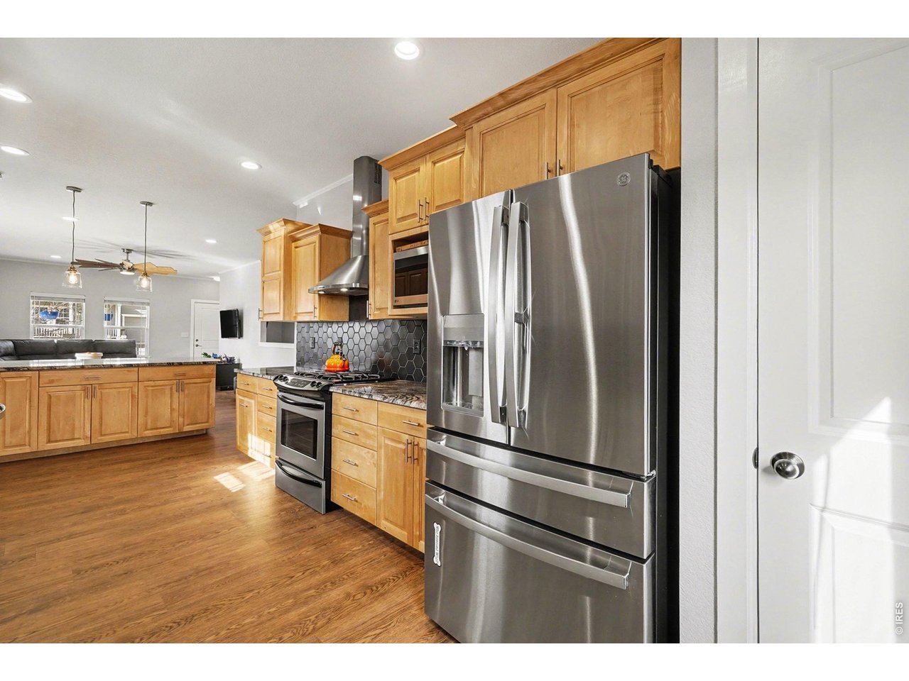 844 Cliffrose Way Severance, CO 80550 - Photo 12 of 50 a kitchen with stainless steel appliances a refrigerator and a stove top oven