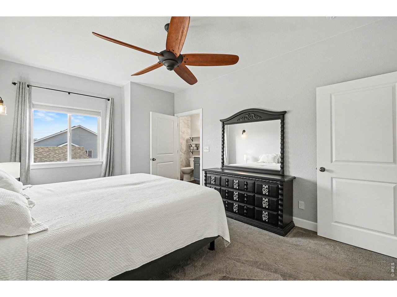 844 Cliffrose Way Severance, CO 80550 - Photo 16 of 50 a bedroom with a bed and a chandelier