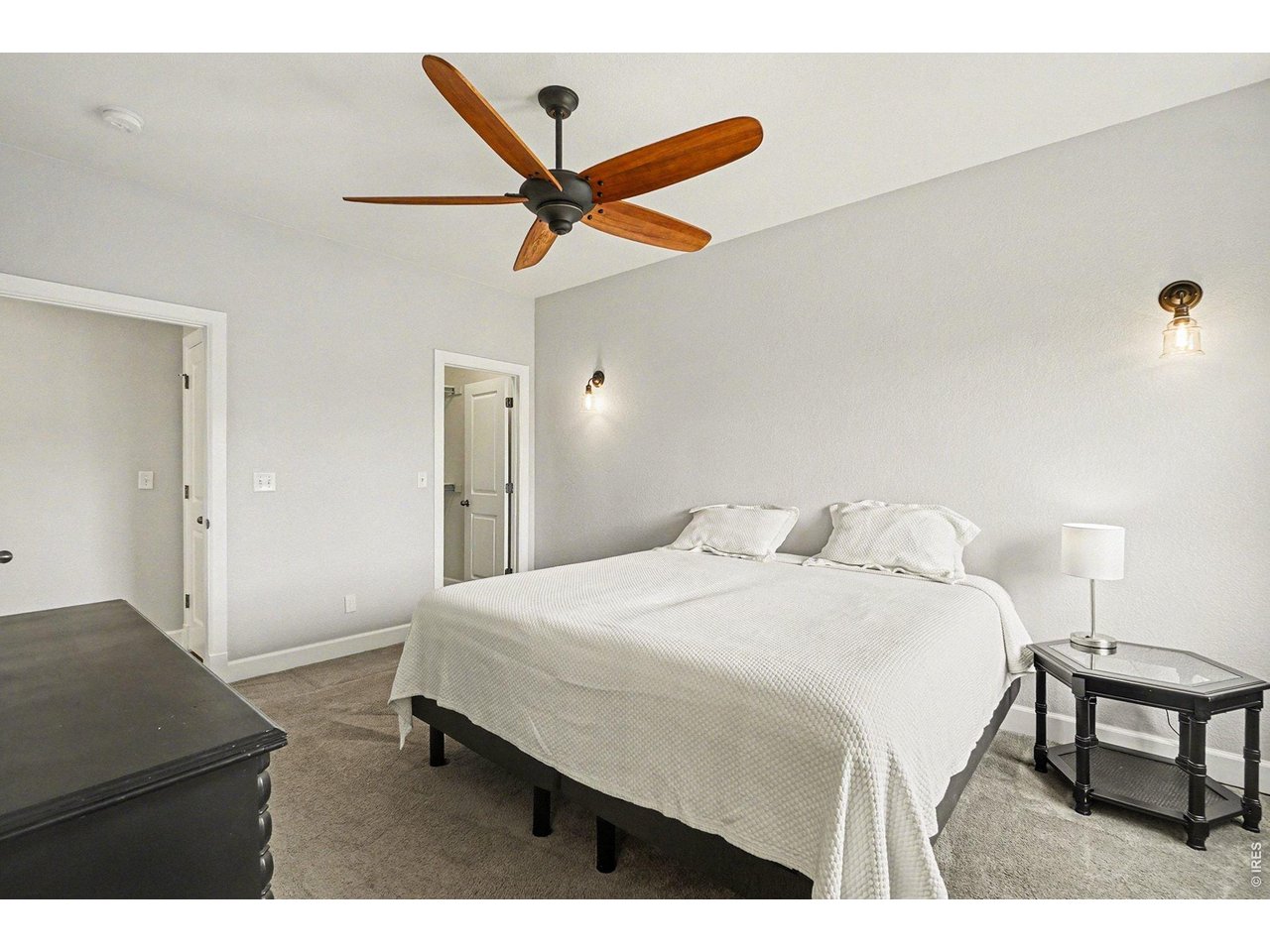 844 Cliffrose Way Severance, CO 80550 - Photo 18 of 50 a bedroom with a bed and a chandelier