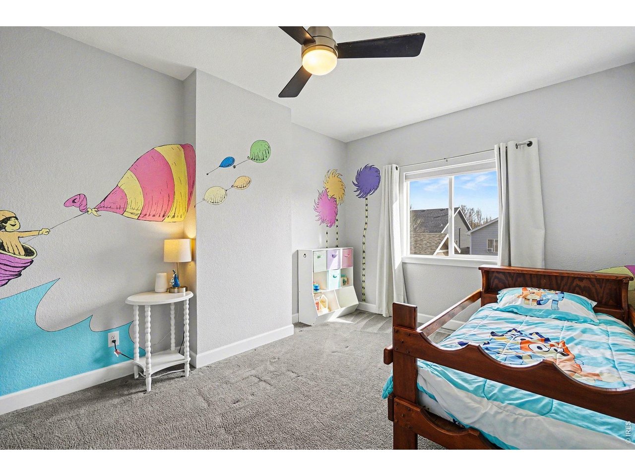 844 Cliffrose Way Severance, CO 80550 - Photo 23 of 50 a bedroom with a bed and a chandelier