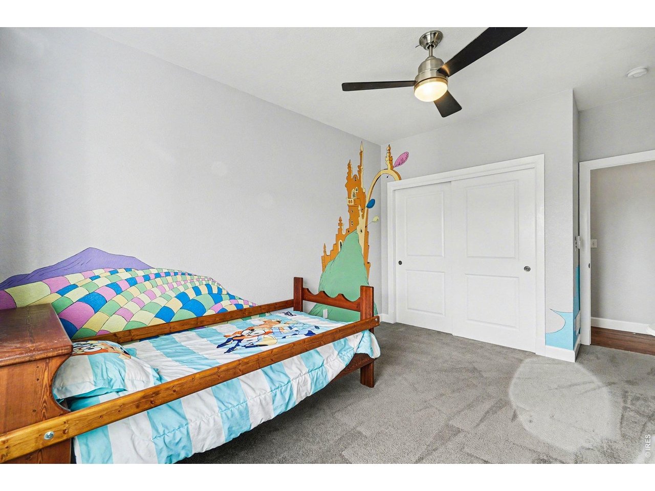 844 Cliffrose Way Severance, CO 80550 - Photo 24 of 50 a bedroom with a bed and a wooden floor