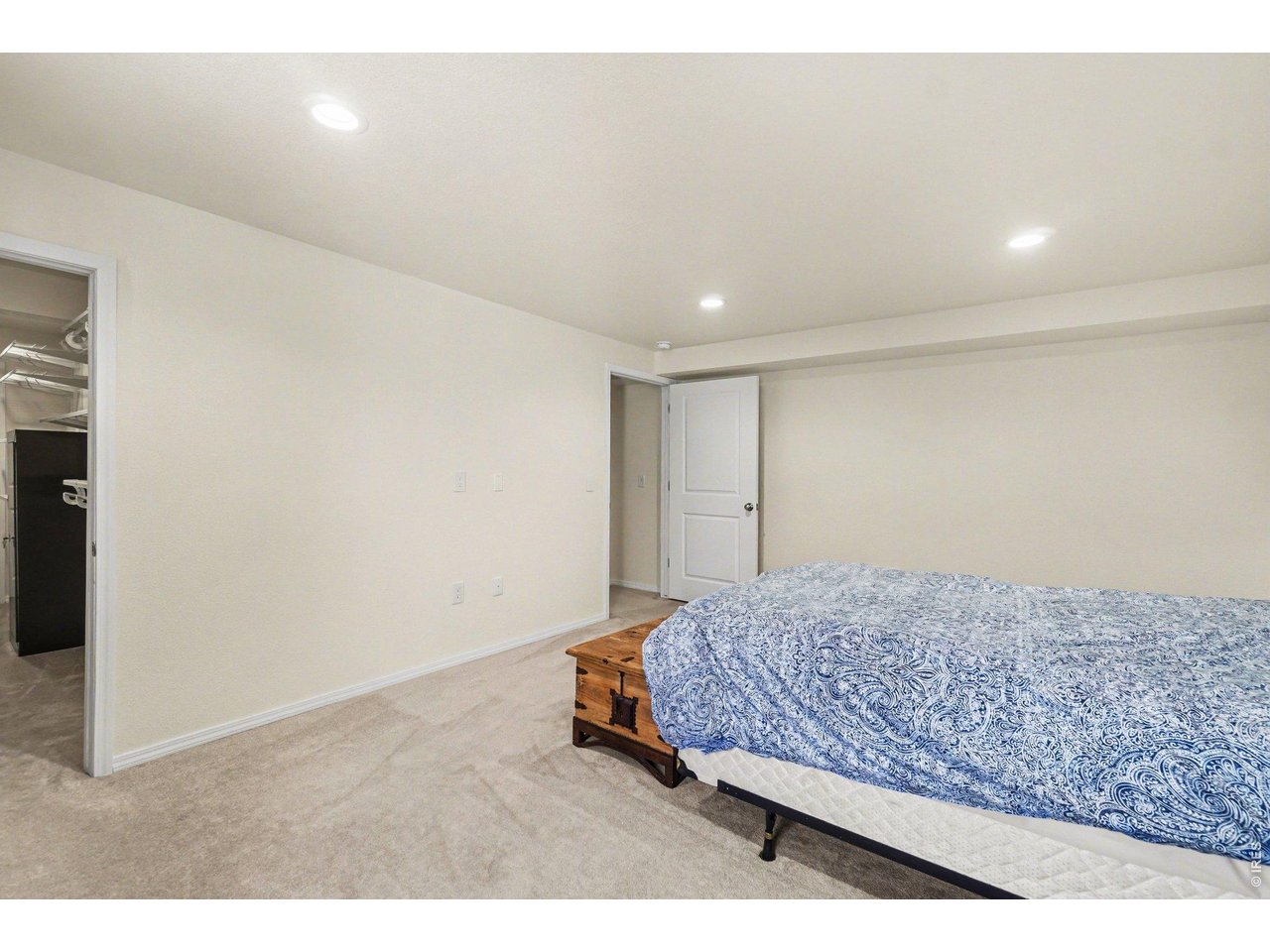 844 Cliffrose Way Severance, CO 80550 - Photo 27 of 50 a bedroom with a bed and cabinet