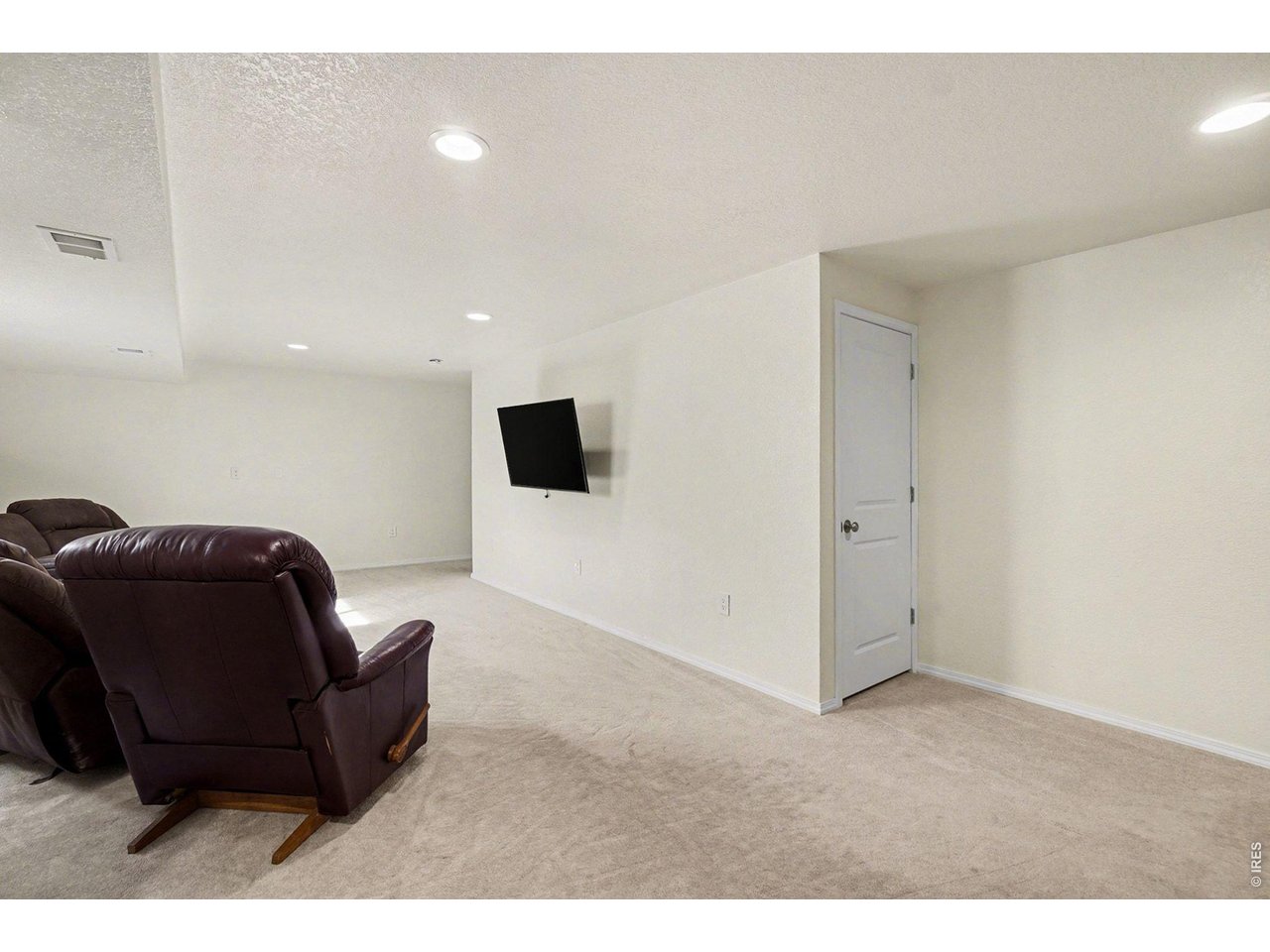 844 Cliffrose Way Severance, CO 80550 - Photo 32 of 50 a living room with furniture and a flat screen tv