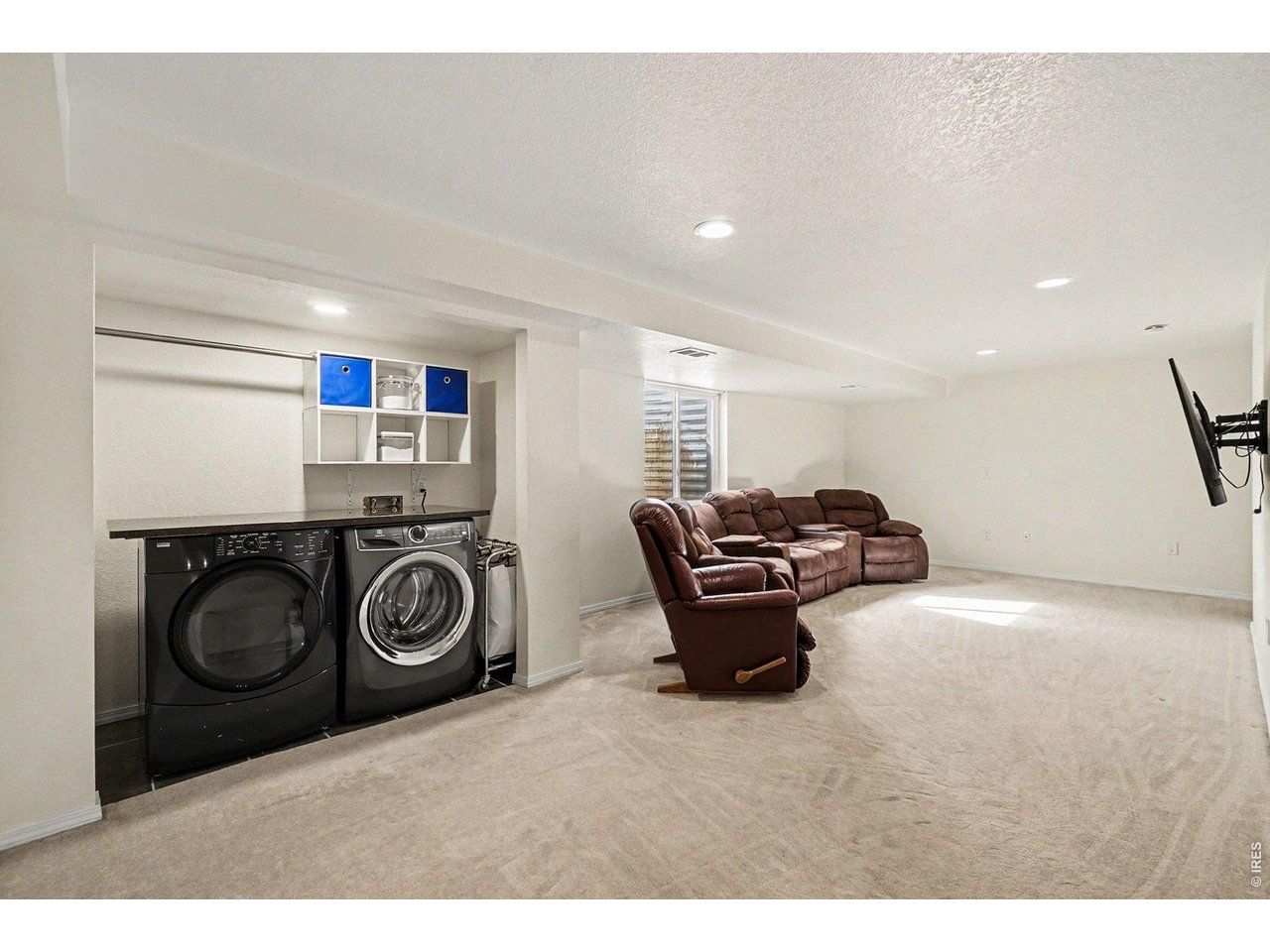 844 Cliffrose Way Severance, CO 80550 - Photo 34 of 50 a living room with furniture a washer and dryer