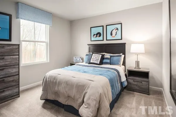 a bedroom with a bed and window